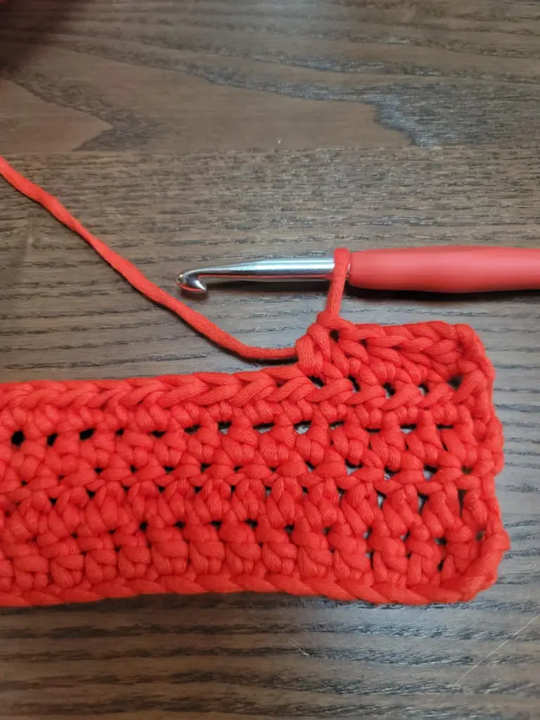 Picture of one loop on the hook from previous stitch to start an HDC2TOG stitch.