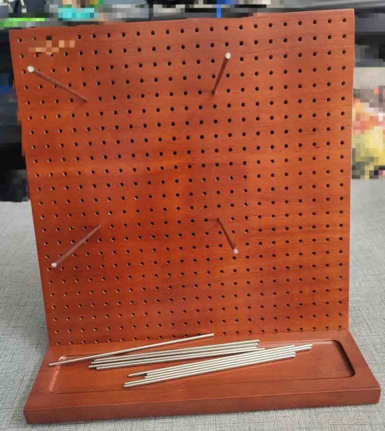 Picture of an empty crochet blocking board with pins.