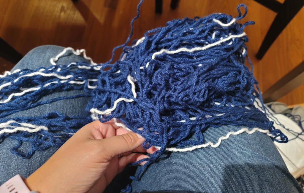 image of yarn in my lap all tangled in a big pile from frogging