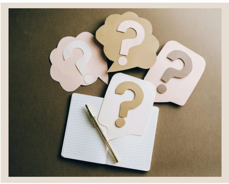 Question marks next to a notebook and pen