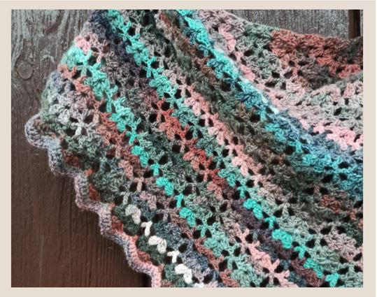 colorful crochet blanket against a wooden background