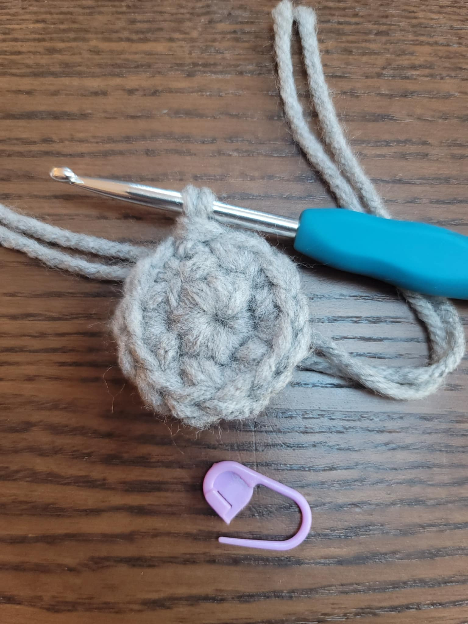 gray crochet magic circle made using 2 yarn strands at once